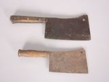 two old tools that are on a white surface