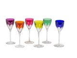 six different colored wine glasses are lined up in a row