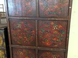 an image of a wooden cabinet with four drawers and a vase on top of it