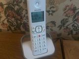 a phone that is sitting on a stand on a table
