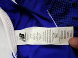 a person holding a label on a blue and white jacket