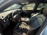 the interior of a car with the door open and the driver ' s seat up