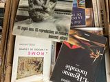 many books in a box that are sitting on the floor