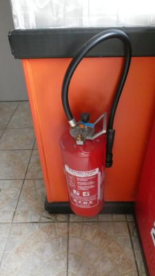 a fire extinguisor in the corner of a kitchen