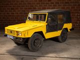 a yellow jeep parked in front of a brick wall
