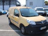 a yellow van parked in a parking lot next to other cars