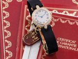 a watch sitting on top of a book on a table