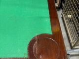 a table with a green cloth on it in a room