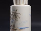 a white vase with a picture of a beach scene on it