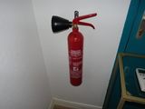a fire extinguisor attached to a wall in a room