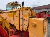 a large yellow crane that is parked in a parking lot