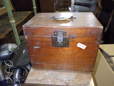 a wooden chest with a metal lid and a metal handle
