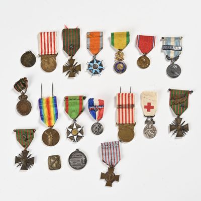 an assortment of medals and medals are arranged on a white surface