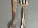 two forks and two spoons on a table