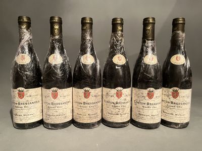 six bottles of wine lined up in a row on a table