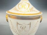 an image of a white and gold bowl with a crest on it