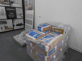 a room with a bed and a bunch of boxes on the floor
