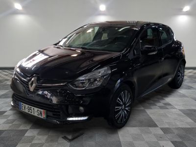 the black car is parked on a checkered floor in the garage