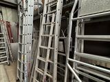 many ladders that are stacked up in a warehouse