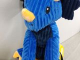 a blue stuffed animal sitting on top of a yellow scooter
