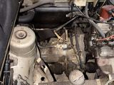 a dirty engine in the back of an old car