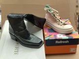 two pairs of shoes that are on top of a box