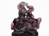 sculpture of a woman sitting on a rock with a flower in her hand