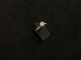 an image of a diamond ring on a black surface