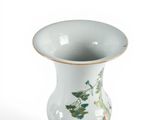 a white vase with a floral design on it