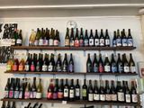 many bottles of wine on the shelves in the store