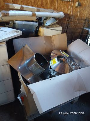 a pile of junk in a room with a lot of boxes on the floor