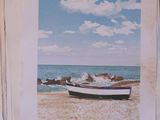 a painting of a boat on the beach next to the ocean