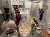many glass vases sitting on a glass table