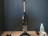 a vacuum that is sitting on a table next to other items
