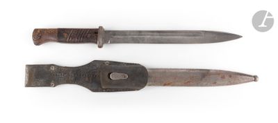 two knives that are sitting side by side on a white surface