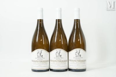 three bottles of wine sitting on top of a white table