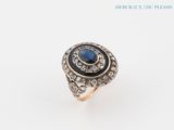 an image of a diamond and sapphire ring on a white background