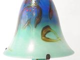 a blue and green lamp that is on a table