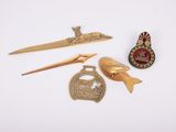 Plusieurs types d'objets métalliques sont exposés sur une surface blanche