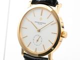 a gold watch with a white dial on a black leather strap