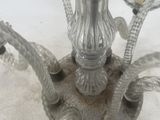 an image of a metal candle holder with a glass candle on it