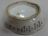 a white bowl with writing on it sitting on a table