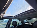 a man sitting in the back seat of a car looking out the window