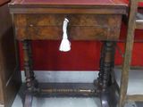 a wooden table with a tassel on top of it