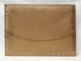 an image of a brown leather case sitting on top of a white table