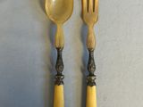 two forks and a spoon on a table