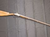 an old rifle with a wooden handle on a black background