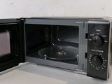 a small black microwave oven sitting on a counter