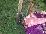 a couch and a pair of swords in the grass