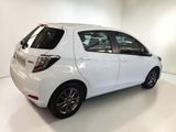 the white car is parked in the white room of the showroom